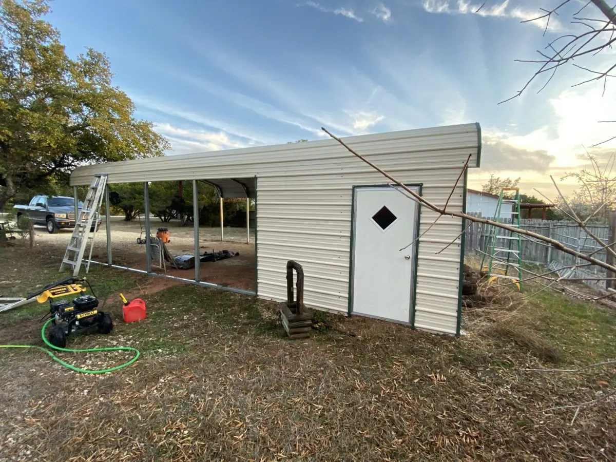 Metal structure with washing equipment and hose beside it